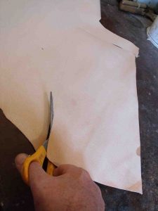 A piece of leather is cut to size and then prepared for use.